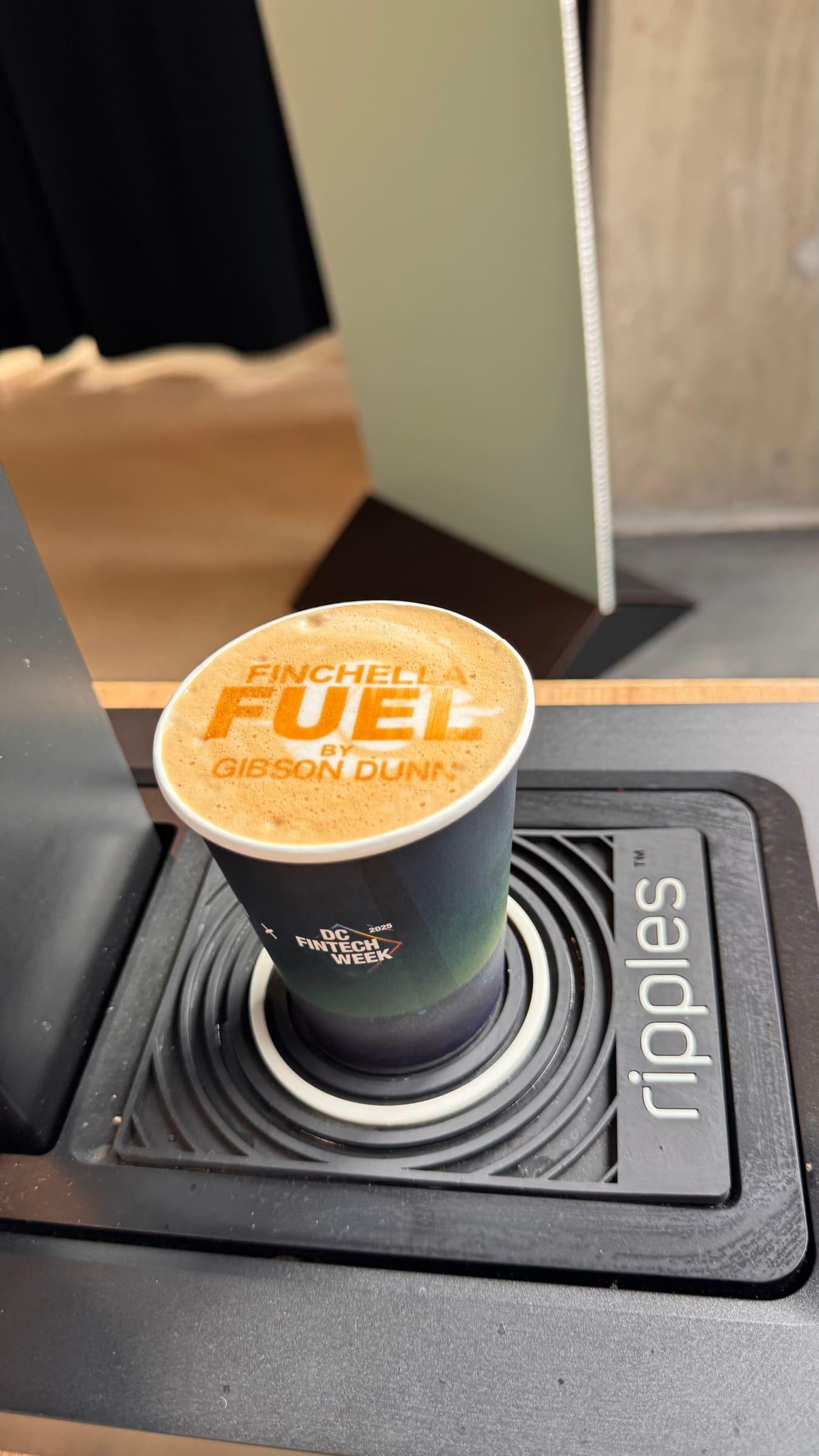 A latte with a sponsor’s logo printed on the foam